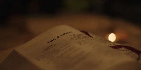 Open bible with candle Stock Footage 126078001