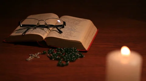 An open bible with a closed glasses Stock Footage 58315741