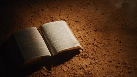 Open Bible on dusty surface.  Shot with RED 8K camera. Stock Footage 130357332