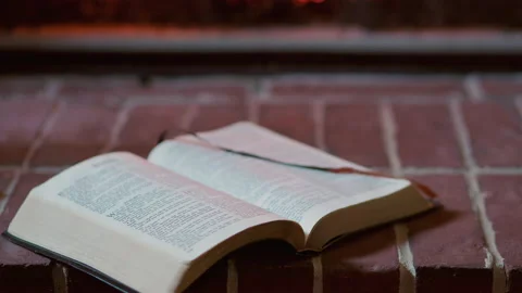 Open bible on a fireplace hearth Stock Footage 148968282