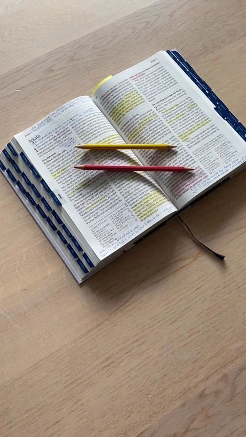 Open Bible flat lay on wooden floor with pencils, highlights and notes Stock Footage 199673363