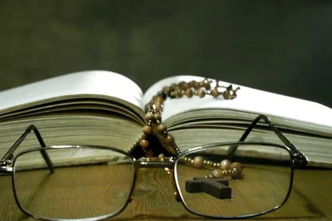 Open Bible with Glasses on the Old Table. Stock Photos