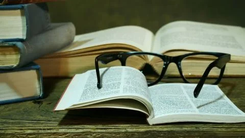 Open Bible with Glasses on the Old Table. Stock Photos