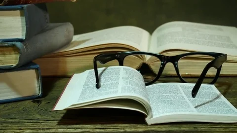 Open Bible with Glasses on the Used Table. Zoom in. Stock Footage 84713681