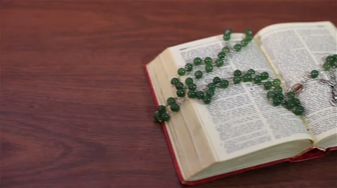 An open bible with rosary Stock Footage 58393526
