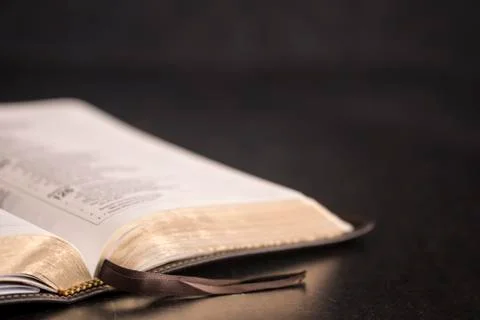 Open Bible on a Slate Tabletop with Customizable Space to Add Text Stock Photos