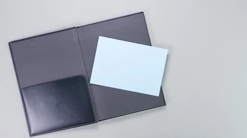 Open Black Folder with Blank Blue Card for Message or Presentation, Isolated on Stock Photos