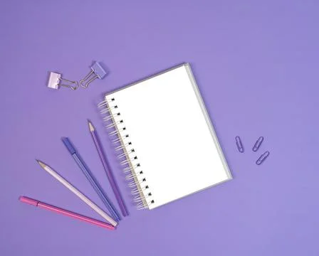 Open blank cketchbook, liners and pencils on purple background Stock Photos