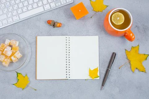 Open blank diary notebook, calendar with yellow leaves and tea candle, sweets Stock Photos