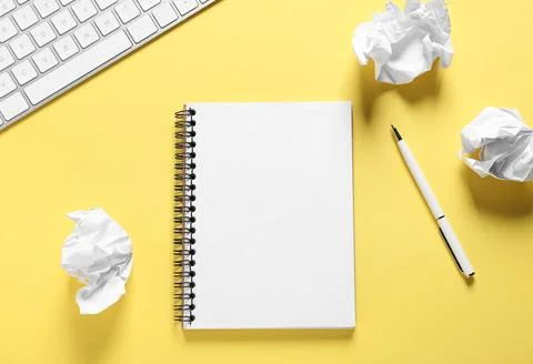 Open blank notebook, crumpled paper, pen and computer keyboard on yellow ba.. Stock Photos