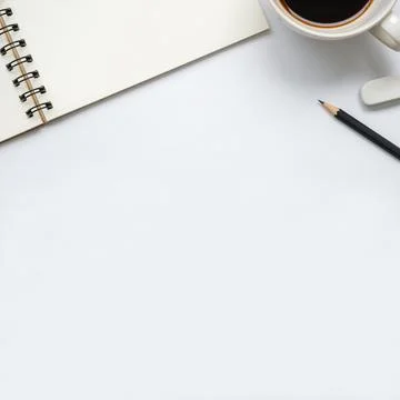 Open blank notebook with cup of coffee, pencil and eraser on white background Foto stock
