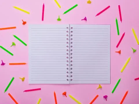 Open blank notebook in a line in the middle of a candle Stock Photos