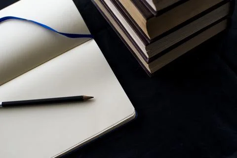 Open blank notebook with a pencil on top Stock Photos