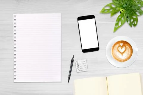 An open blank notebook, smartphone with pen and a cup of latte coffee on wood Stock Photos