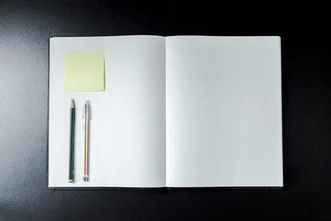 Open blank notebook with stationery accessories. Top view. Post it notes. smi Stock Photos