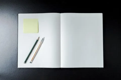 Open blank notebook with stationery accessories. Top view. Post it notes. smi Stock Photos