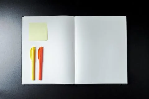 Open blank notebook with stationery accessories. Top view. Post it notes. smi Stock Photos