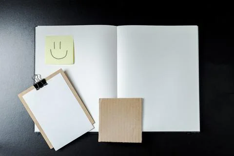 Open blank notebook with stationery accessories. Top view. Post it notes. smi Stock Photos