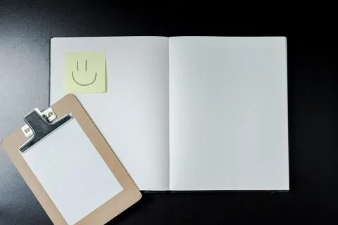 Open blank notebook with stationery accessories. Top view. Post it notes. smi Stock Photos