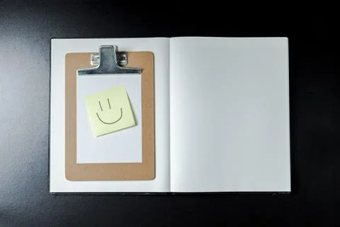 Open blank notebook with stationery accessories. Top view. Post it notes. smi Stock Photos