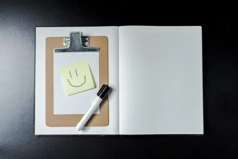 Open blank notebook with stationery accessories. Top view. Post it notes. smi Stock Photos
