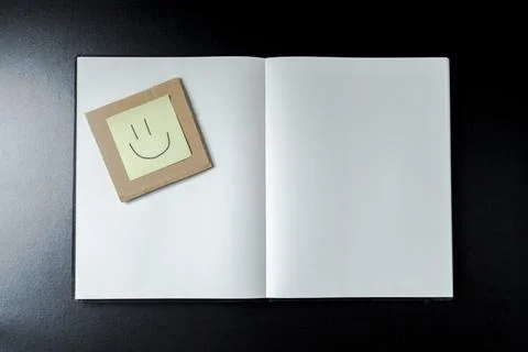 Open blank notebook with stationery accessories. Top view. Post it notes. smi Stock Photos