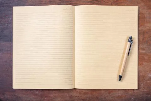 Open blank school notebook or diary and pen, old fashioned, on wooden desk, s Stock Photos