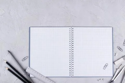 Open blank spiral notebook, gray school supplies on  concrete background Stock Photos
