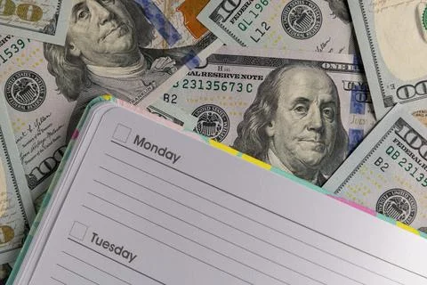 Open Blank Weekly Planner on a Background of One Hundred US Dollar Bills Stock Photos