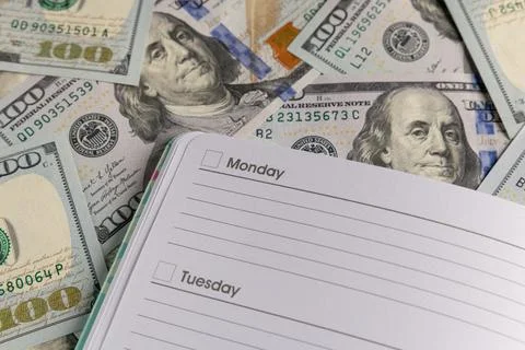 Open Blank Weekly Planner on a Background of One Hundred US Dollar Bills Stock Photos