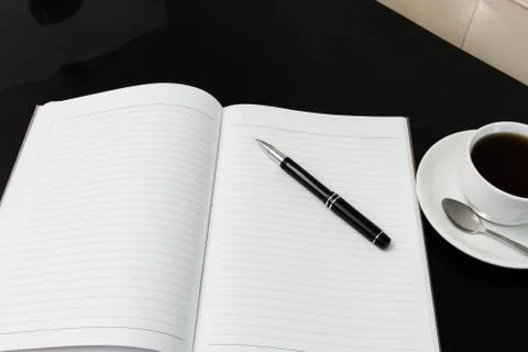 Open a blank white notebook, pen and cup of coffee Stock Photos