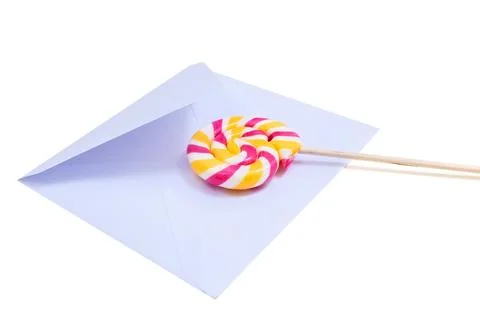 Open blue envelope and lollipop on the white background. Stock Photos
