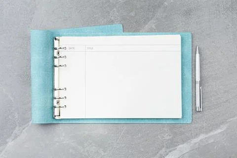 Open blue notebook on a marble background. Stock Photos