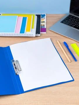 Open blue plastic file folder with blank paper sheet isolated on blue, close  Stock Photos