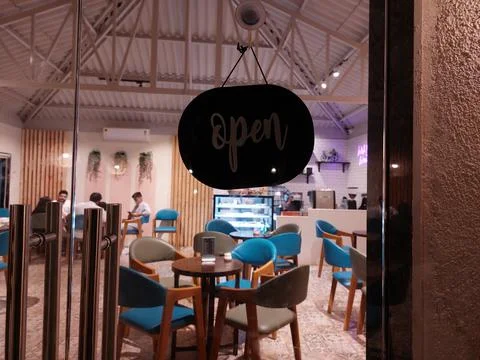"open" board text written on outside door of restaurant Stock Photos