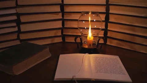 Open book and a burning candle Stock-Footage 77078673