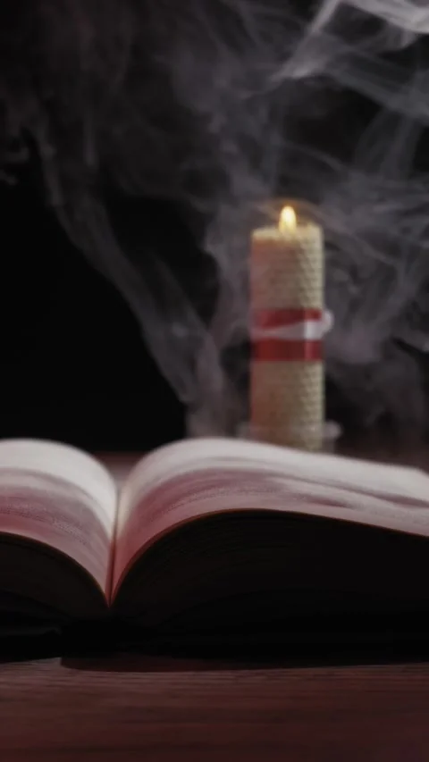 Open Book And Burning Candle With Mysterious Smoke In Dark Room 스톡 동영상 330274418