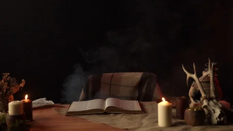 Open book and candles on table with magic items Stock Footage 125027520