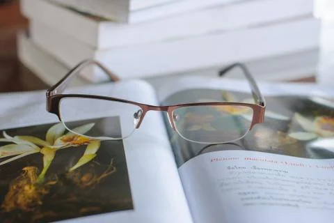 Open book and glasses Stock Photos