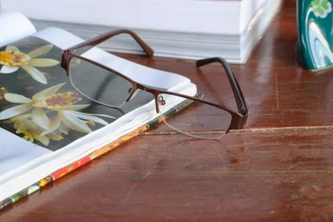 Open book and glasses Stock Photos