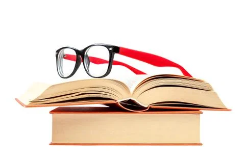 Open book and glasses on a stack of books Stock Photos