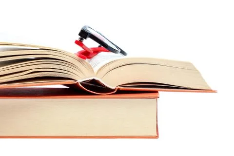 Open book and glasses on a stack of books Stock Photos
