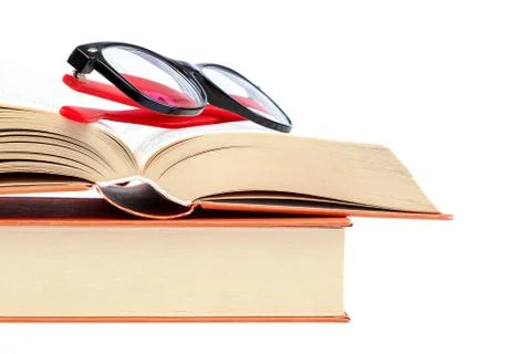 Open book and glasses on a stack of books Stock Photos