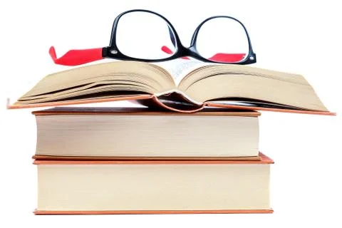 Open book and glasses on a stack of books Stock Photos