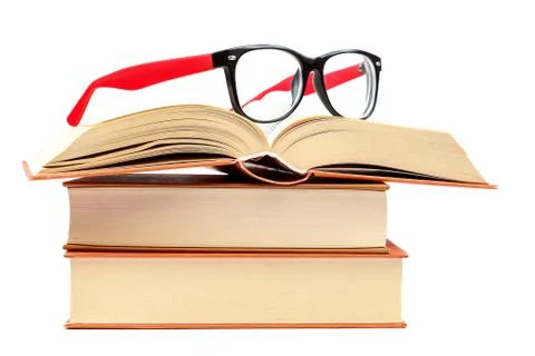 Open book and glasses on a stack of books Stock Photos