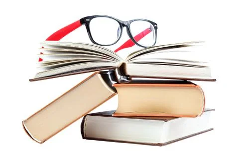 Open book and glasses on a stack of books Stock Photos
