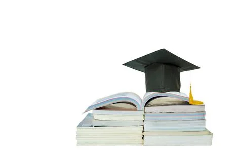 Open book and mortarboard  on stack book. Stock Photos