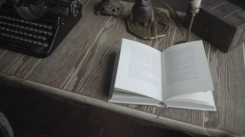 An open book and a typewriter on the desk Stock-Footage 72633819