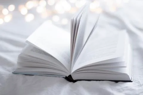 Open book on a bed Stock Photos