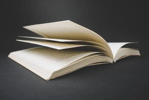 Open book on black background. Stock Photos